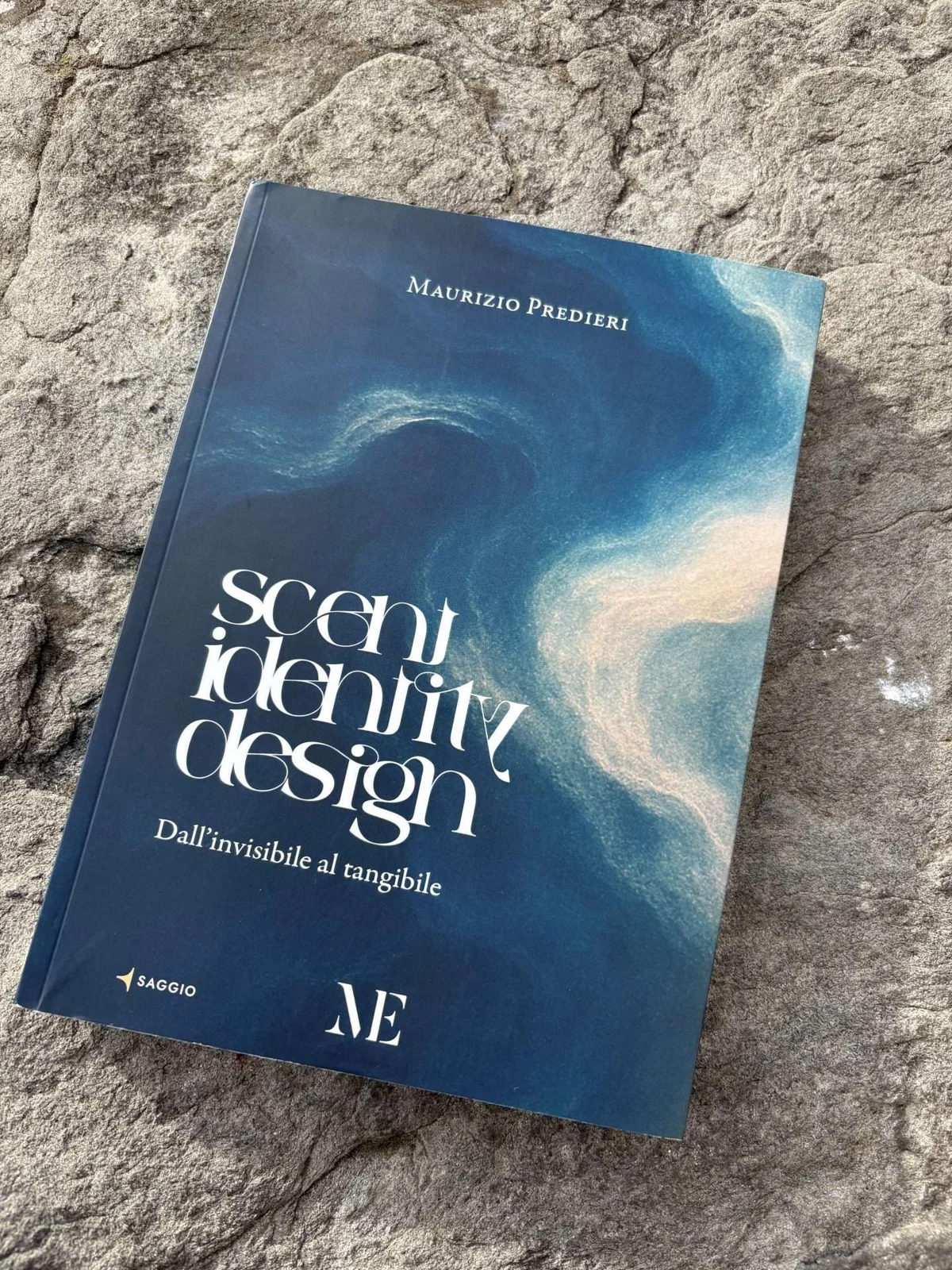 A printed copy of Scent Identity Design on a stone surface