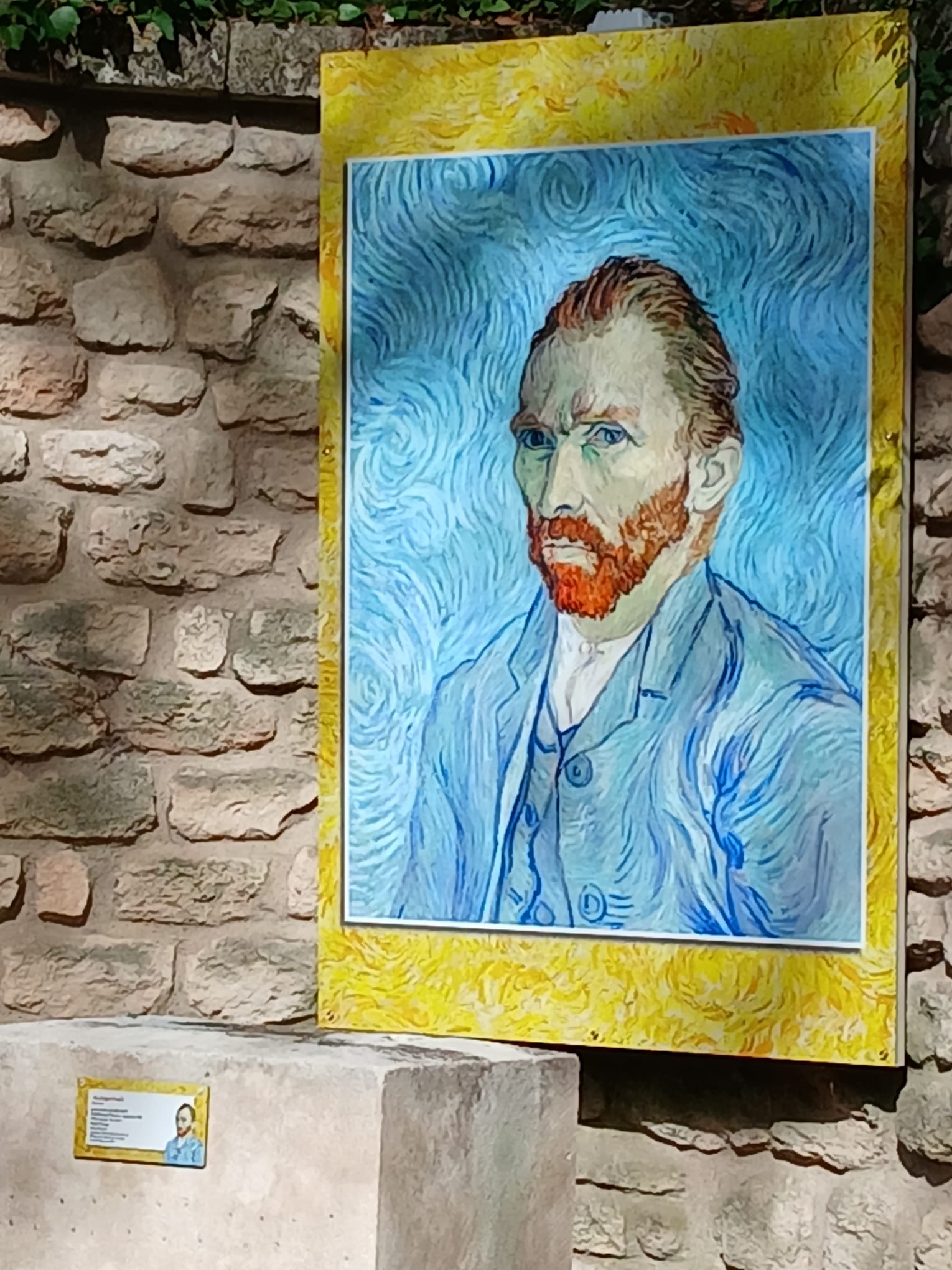 A panel displaying a reproduction of a Vincent van Gogh self-portrait against a stone wall.